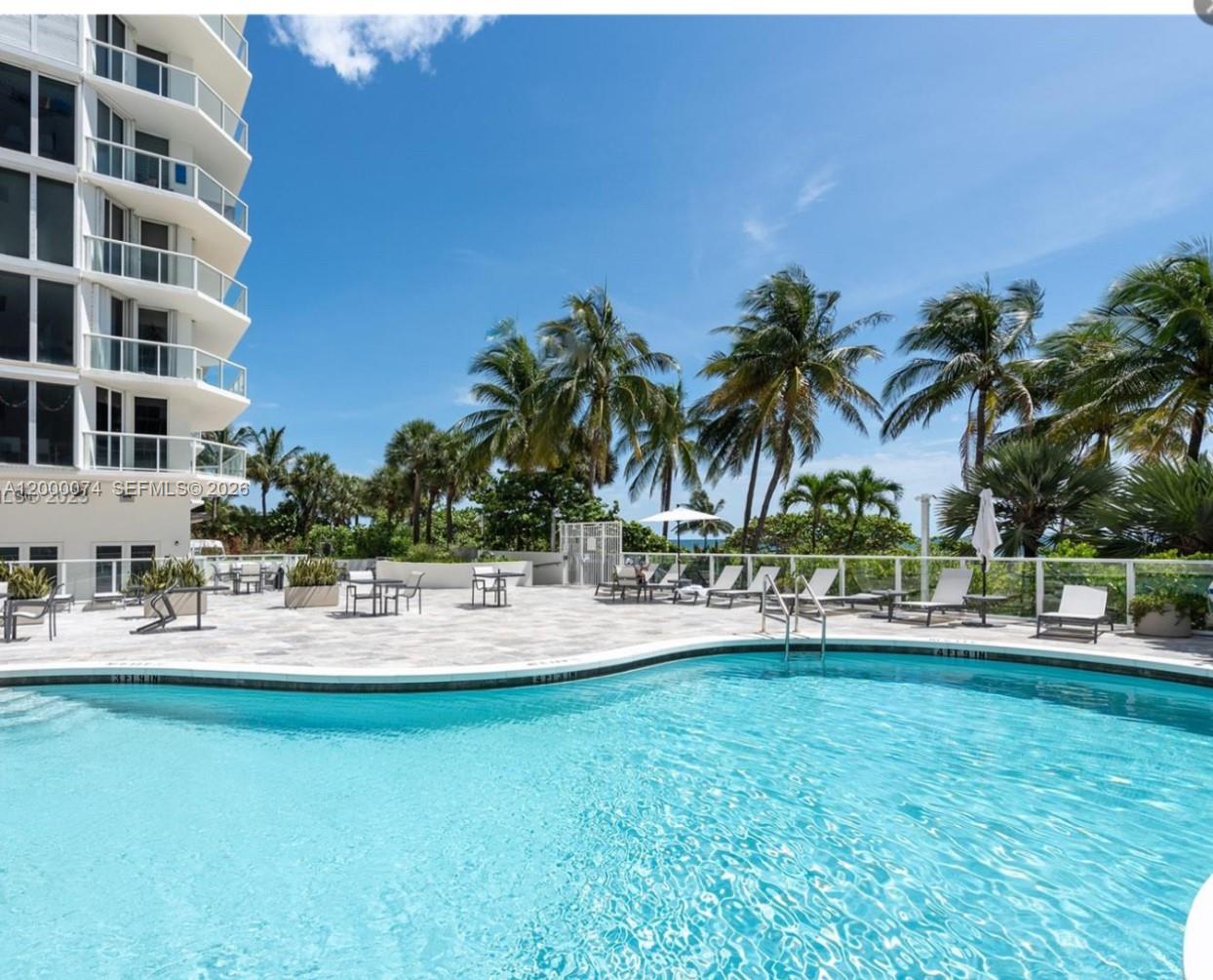 8925 Collins Avenue, Unit 2J Surfside, FL 33154 - Photo 3 of 63 a view of yard with swimming pool and lake view