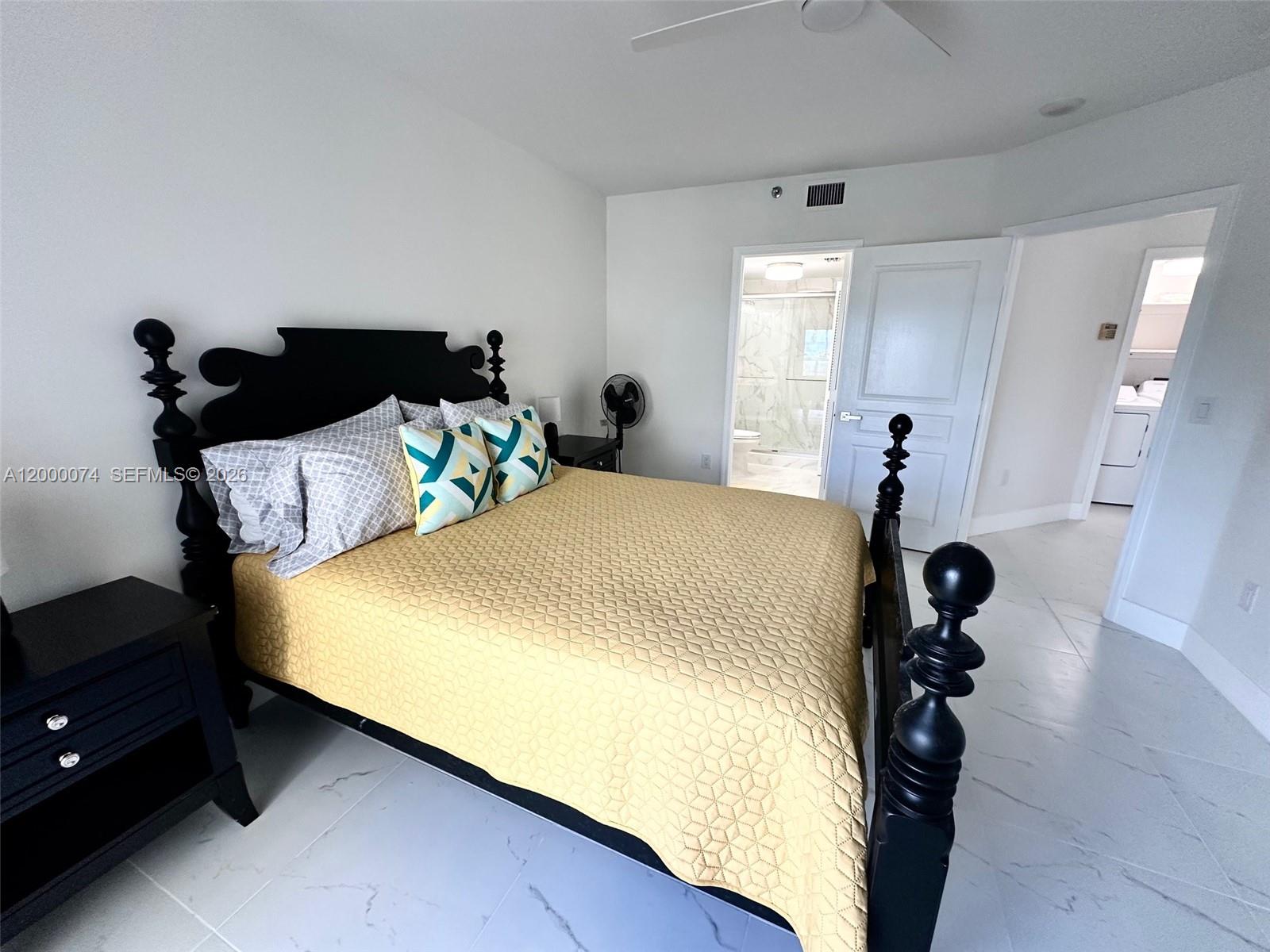 8925 Collins Avenue, Unit 2J Surfside, FL 33154 - Photo 31 of 63 a bedroom with a bed and wooden floor