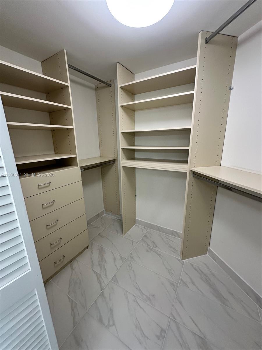 8925 Collins Avenue, Unit 2J Surfside, FL 33154 - Photo 36 of 63 a view of an empty walk in closet