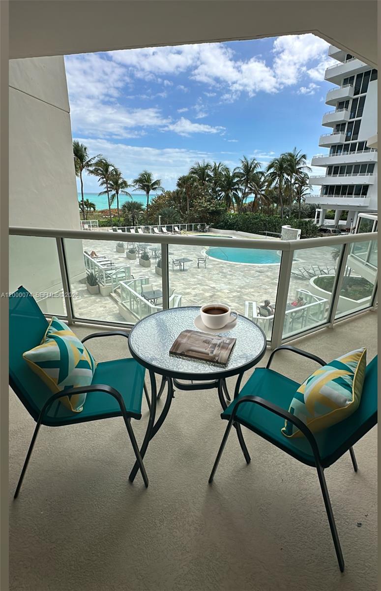 8925 Collins Avenue, Unit 2J Surfside, FL 33154 - Photo 4 of 63 a view of a chairs and table in the terrace