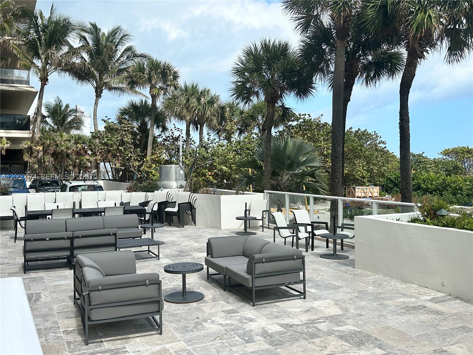 8925 Collins Avenue, Unit 2J Surfside, FL 33154 - Photo 45 of 63 a view of a terrace with couches and a fire pit