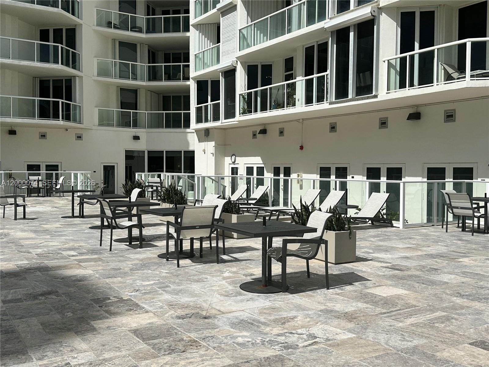 8925 Collins Avenue, Unit 2J Surfside, FL 33154 - Photo 46 of 63 a view of a building with sitting area