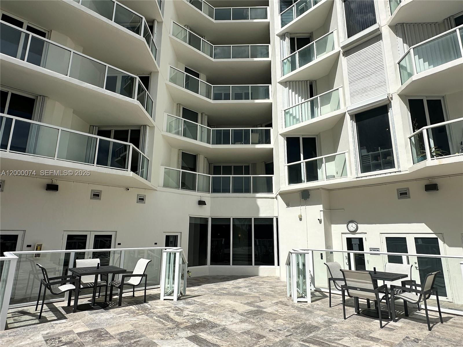 8925 Collins Avenue, Unit 2J Surfside, FL 33154 - Photo 52 of 63 a front view of a building with many windows