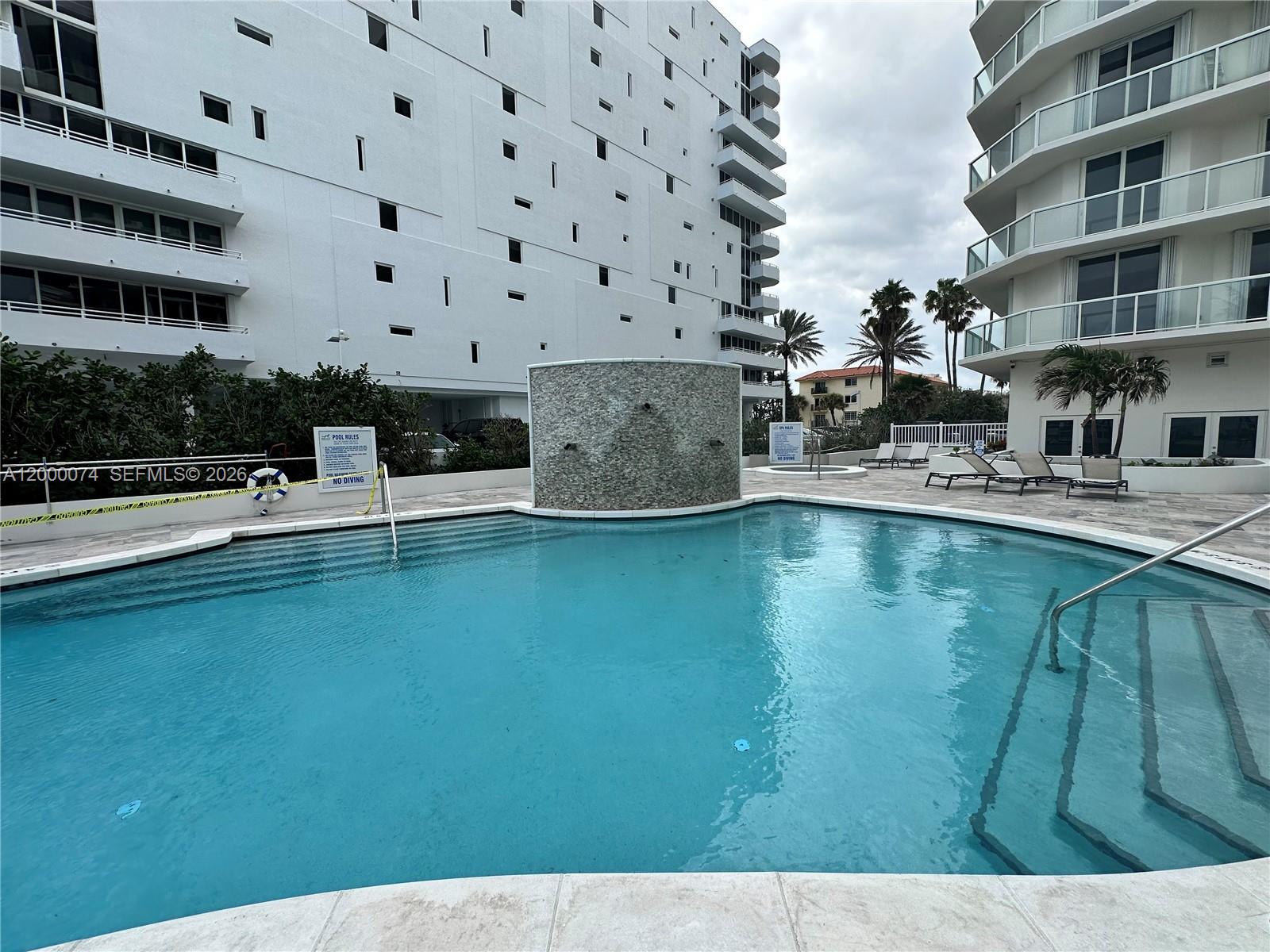 8925 Collins Avenue, Unit 2J Surfside, FL 33154 - Photo 53 of 63 a swimming pool view with a outdoor seating space