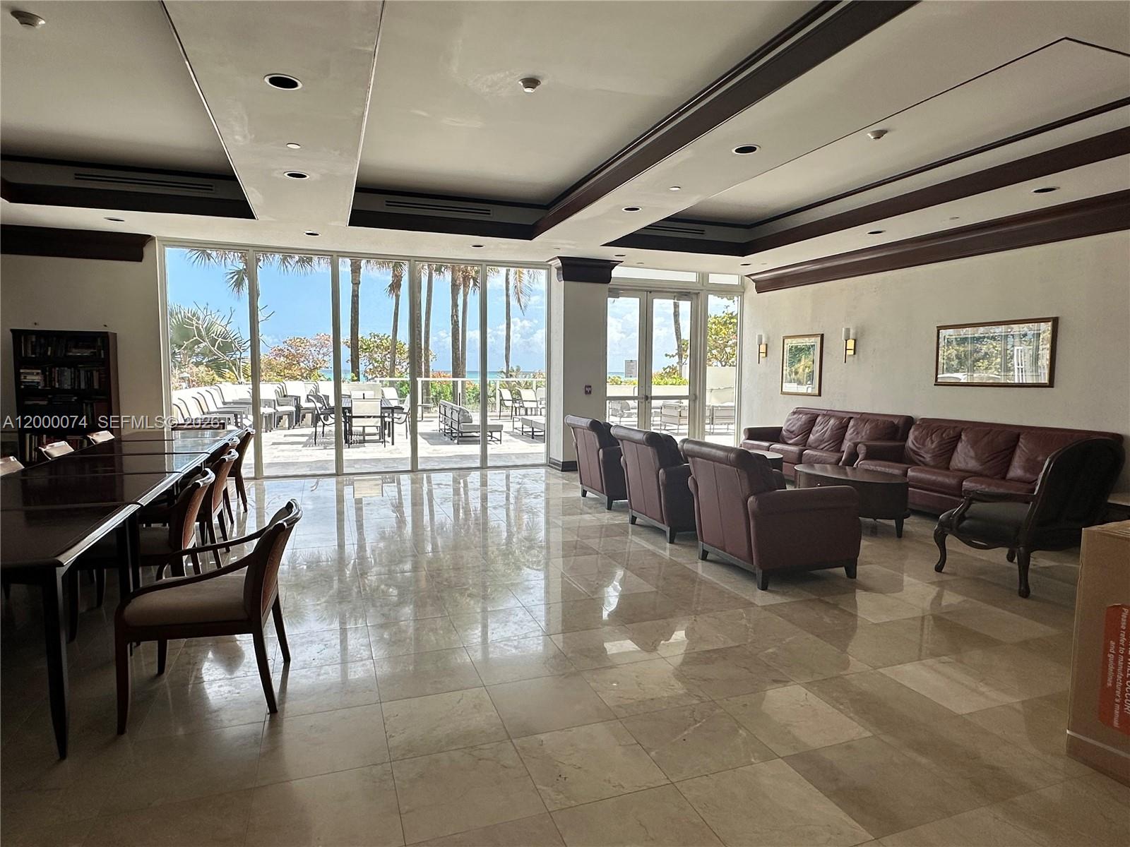 8925 Collins Avenue, Unit 2J Surfside, FL 33154 - Photo 60 of 63 a lobby with furniture and floor to ceiling window