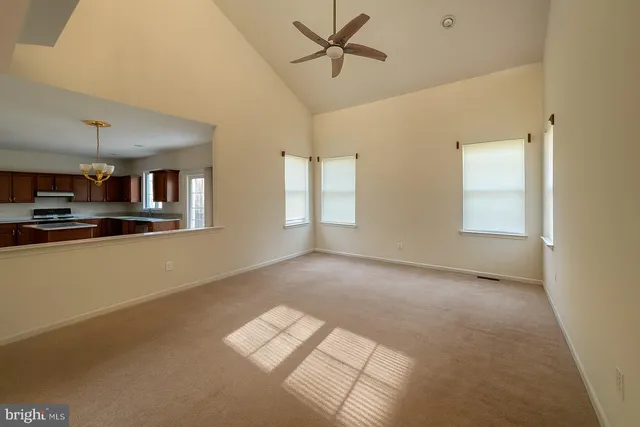 a view of a livingroom with furniture ceiling fan and window
