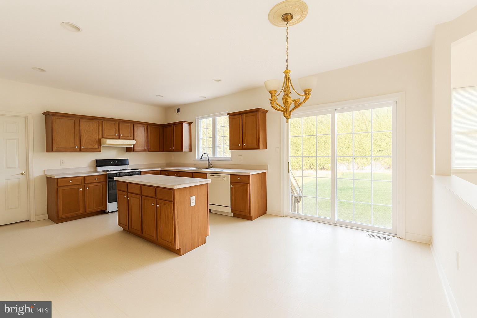 39 Tynemouth Drive Lumberton, NJ 08048 - Photo 8 of 22 a kitchen with stainless steel appliances granite countertop a stove a sink and a refrigerator