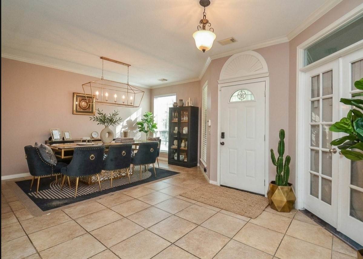 19802 Shavon Springs Drive Spring, TX 77388 - Photo 12 of 30 Elegant dining area featuring stylish lighting, ample natural light, and a sophisticated layout perfect for entertaining. Virtually staged