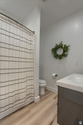 828 South Deer Road Tooele, UT 84074 - Photo 33 of 51 Full bathroom featuring a shower with a striped curtain, a white toilet, and a gray vanity with a white countertop and integrated sink