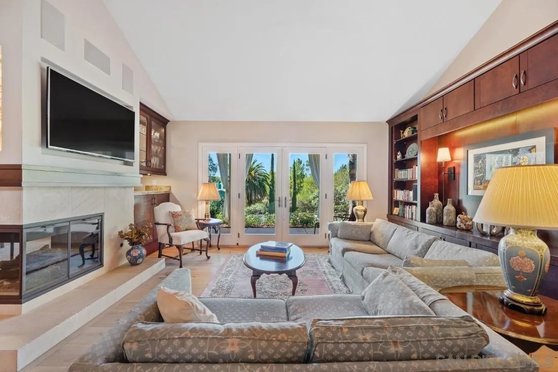 12904 Stone Canyon Road Poway, CA 92064 - Photo 11 of 72 a living room with fireplace furniture and a flat screen tv