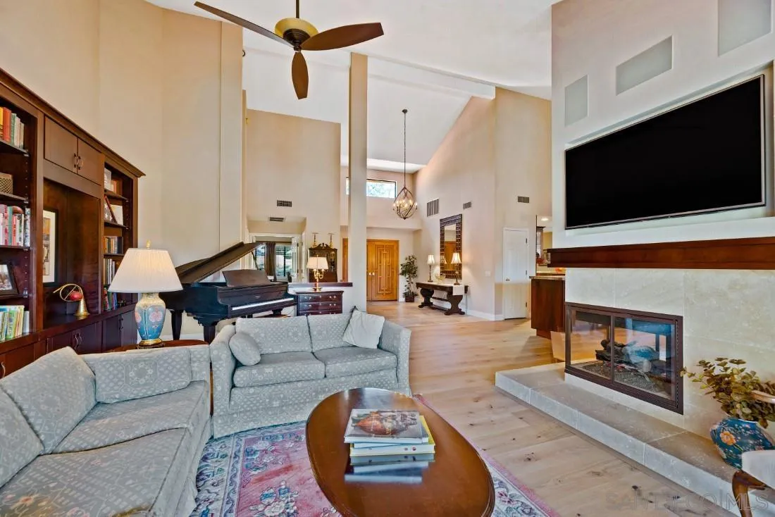 12904 Stone Canyon Road Poway, CA 92064 - Photo 12 of 72 a living room with furniture and a flat screen tv