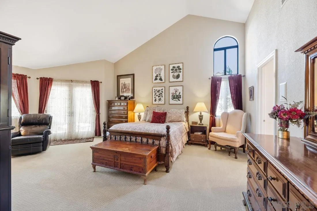 12904 Stone Canyon Road Poway, CA 92064 - Photo 15 of 72 a spacious bedroom with a bed and a couch