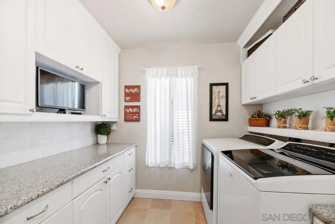 12904 Stone Canyon Road Poway, CA 92064 - Photo 25 of 72 a kitchen with stainless steel appliances granite countertop a sink stove and cabinets