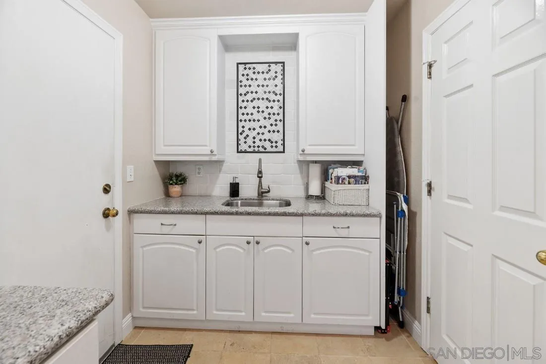 12904 Stone Canyon Road Poway, CA 92064 - Photo 26 of 72 a bathroom with granite countertop a sink and a mirror