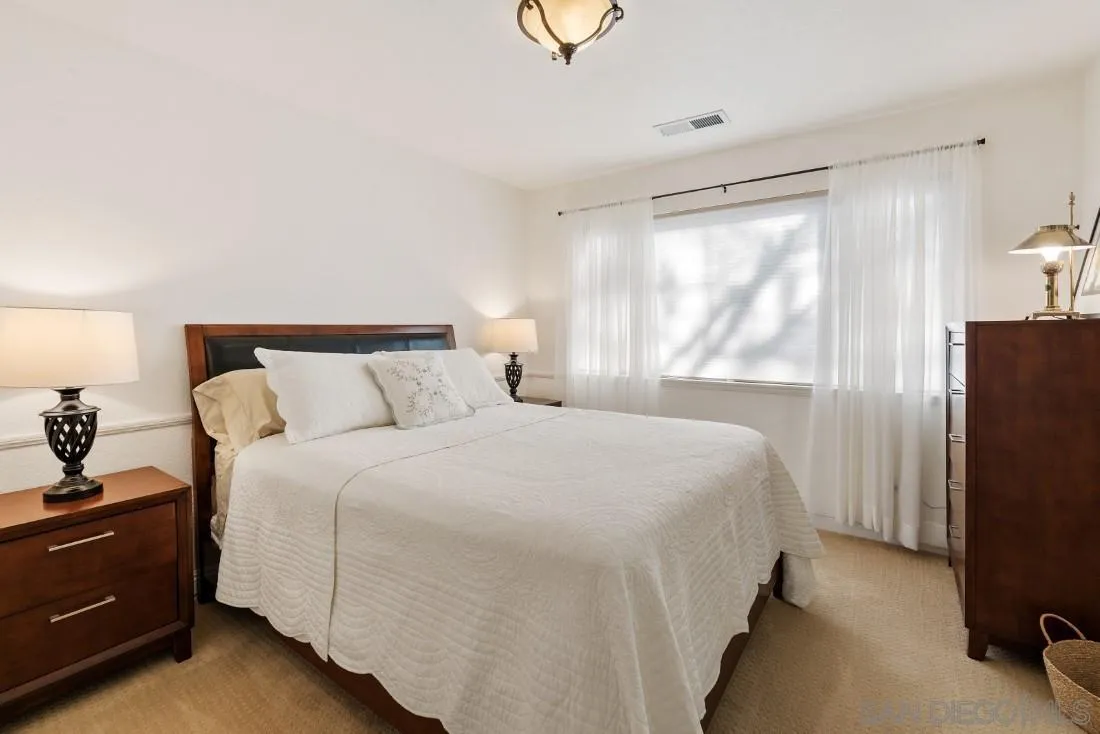 12904 Stone Canyon Road Poway, CA 92064 - Photo 27 of 72 a bedroom with a bed and a large window