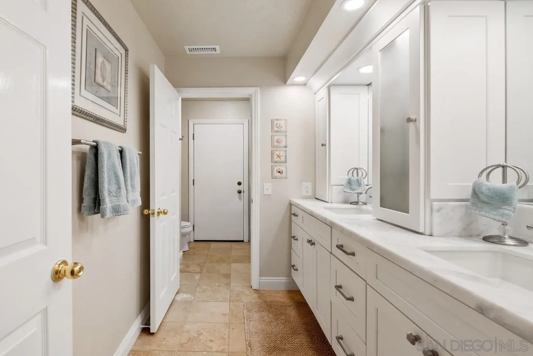 12904 Stone Canyon Road Poway, CA 92064 - Photo 31 of 72 a spacious bathroom with a double vanity sink a mirror and shower