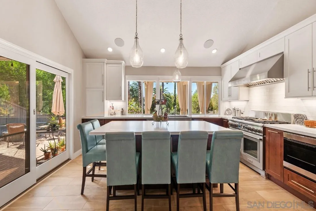12904 Stone Canyon Road Poway, CA 92064 - Photo 35 of 72 a dining table with chairs and kitchen view