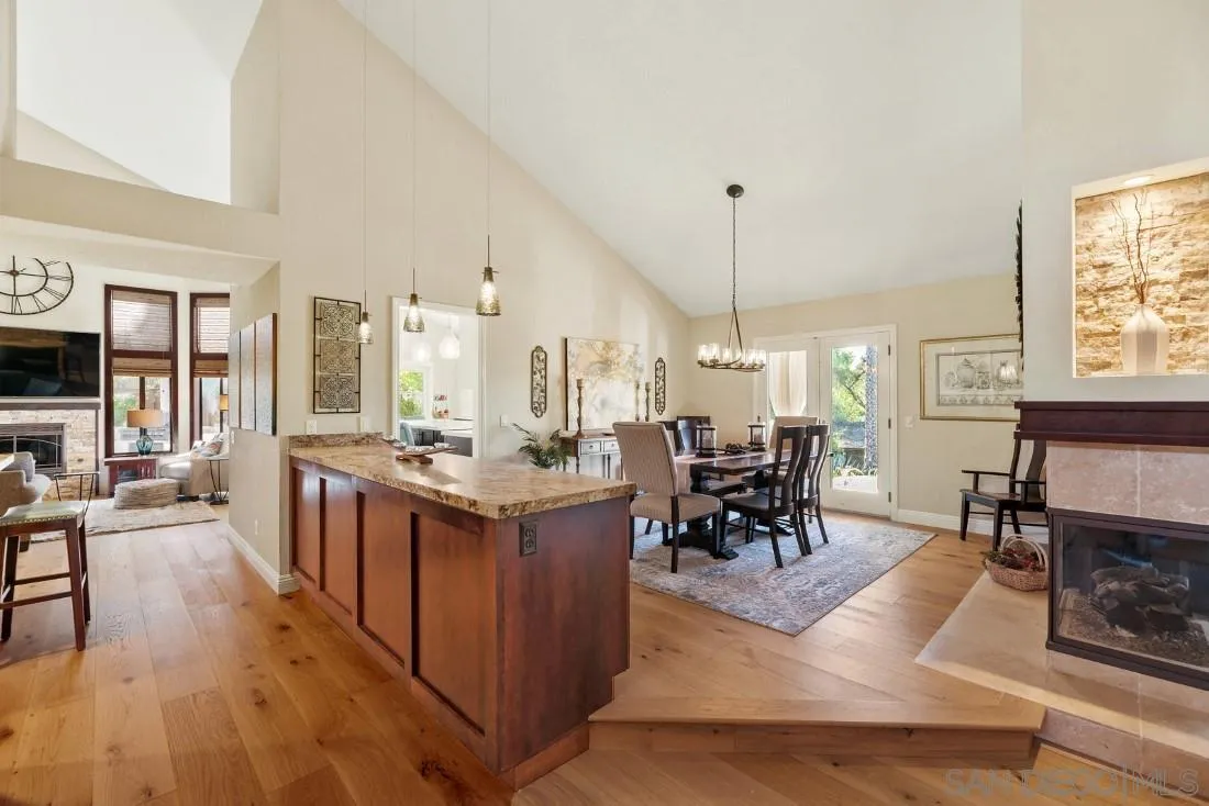12904 Stone Canyon Road Poway, CA 92064 - Photo 46 of 72 a living room with furniture a dining table and a fireplace