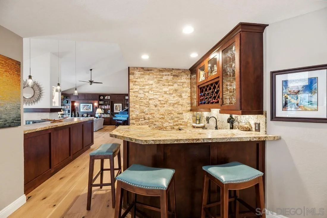 12904 Stone Canyon Road Poway, CA 92064 - Photo 50 of 72 a kitchen with stainless steel appliances kitchen island granite countertop a sink and cabinets