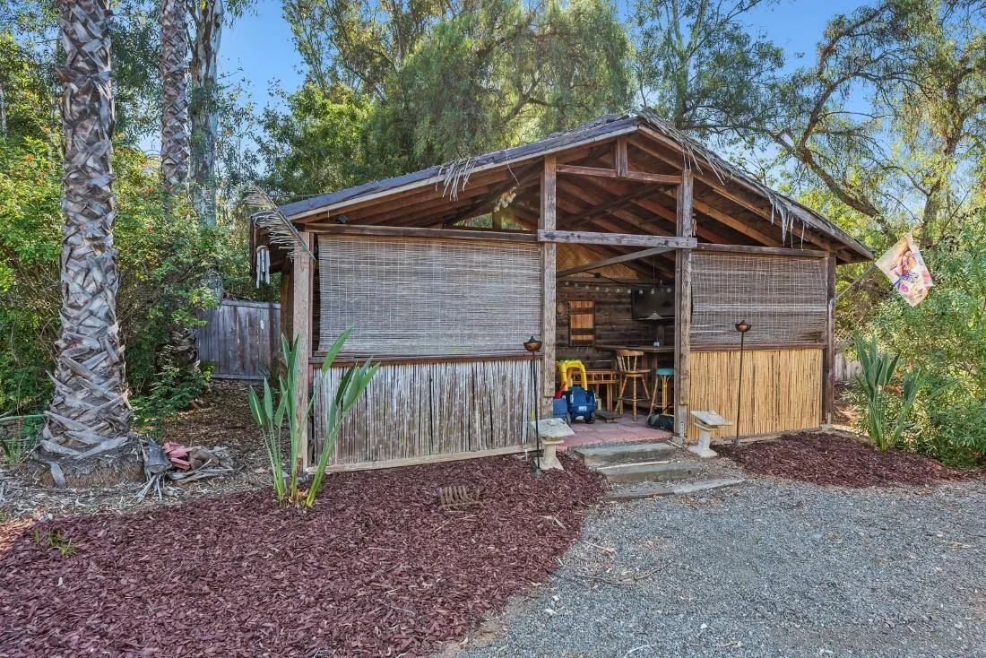 12904 Stone Canyon Road Poway, CA 92064 - Photo 66 of 72 a front view of a house with a yard and garage