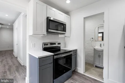 a kitchen with a sink and a stove top oven