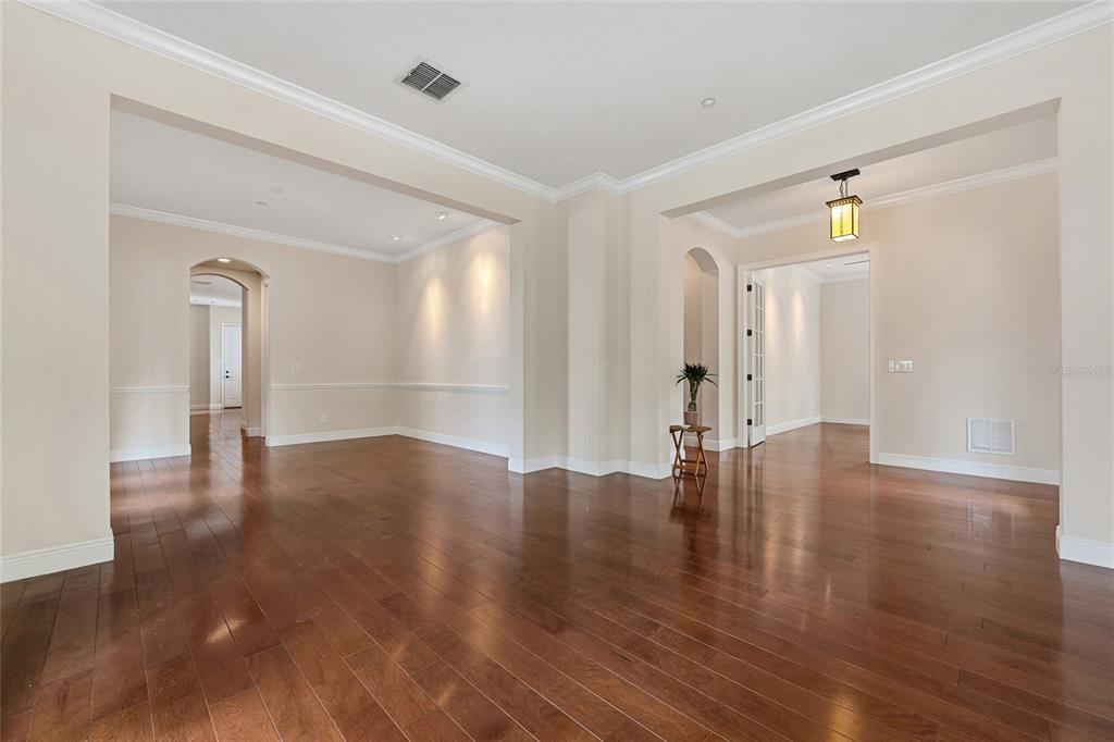 1027 Juel Street Orlando, FL 32814 - Photo 16 of 78 a view of empty room with wooden floor and windows