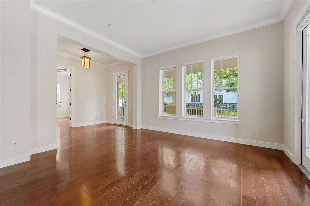 1027 Juel Street Orlando, FL 32814 - Photo 18 of 78 a view of an empty room with wooden floor and a window