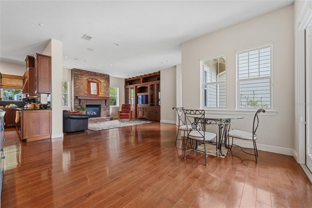1027 Juel Street Orlando, FL 32814 - Photo 23 of 78 a living room with furniture and a dining table with wooden floor