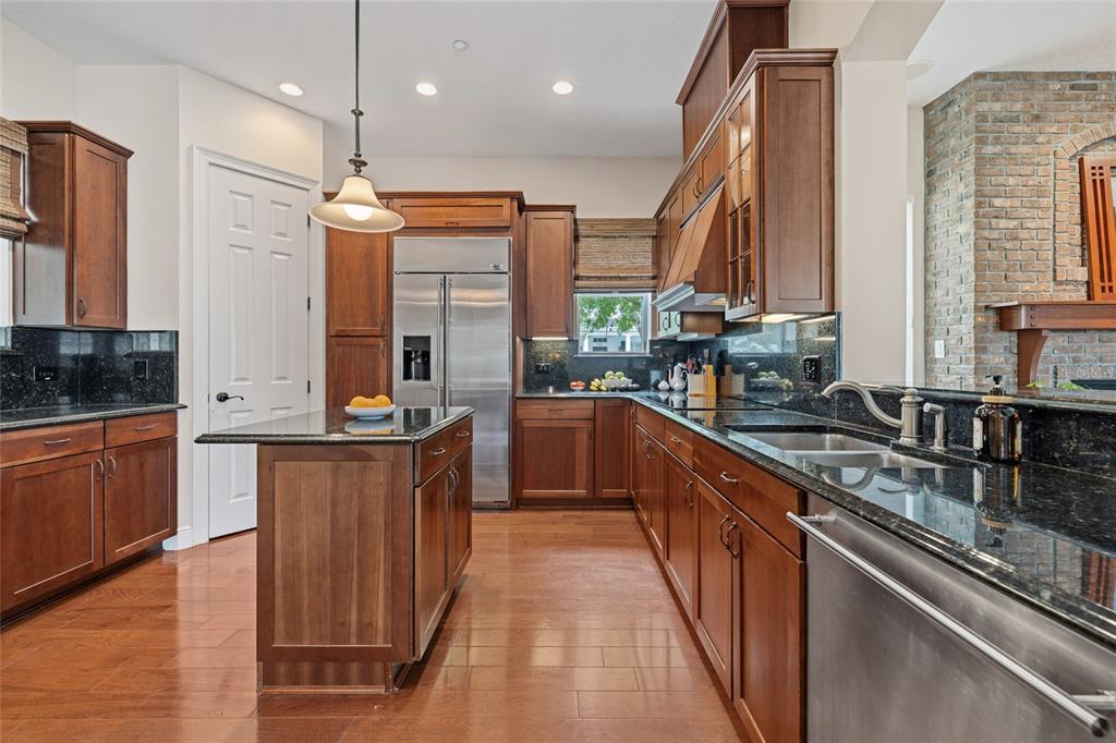 1027 Juel Street Orlando, FL 32814 - Photo 28 of 78 a kitchen with stainless steel appliances a sink stove and cabinets