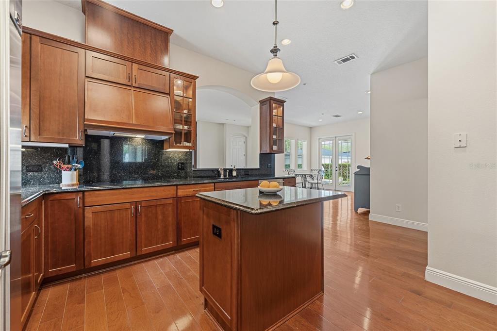 1027 Juel Street Orlando, FL 32814 - Photo 30 of 78 a kitchen with stainless steel appliances granite countertop a sink a stove and a wooden floors