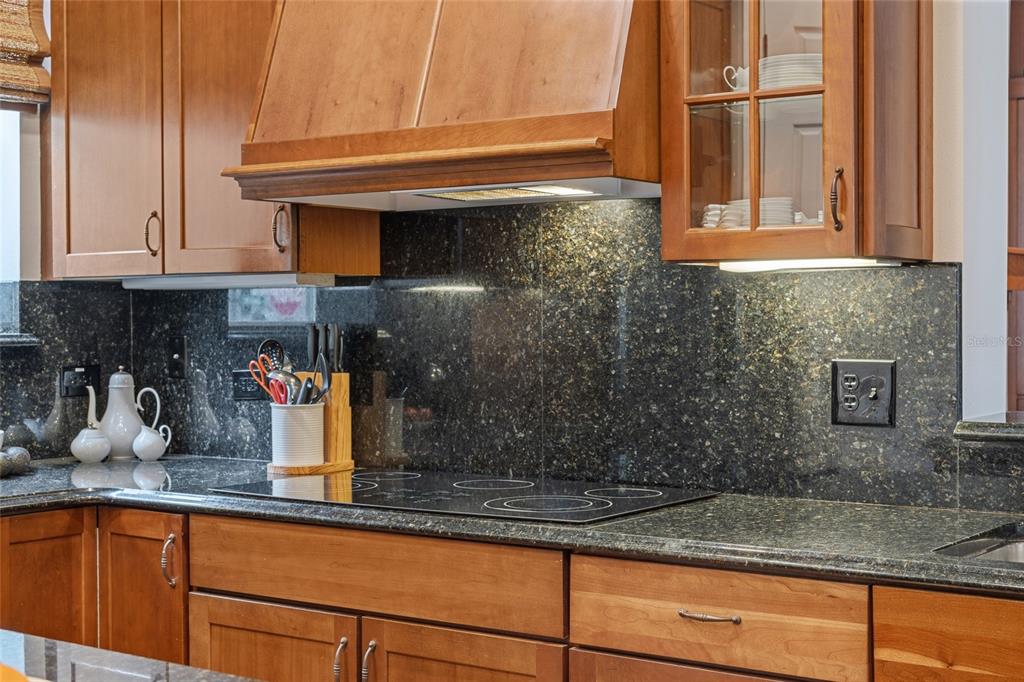 1027 Juel Street Orlando, FL 32814 - Photo 31 of 78 a kitchen with granite countertop a sink and cabinets
