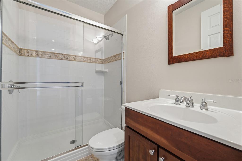 1027 Juel Street Orlando, FL 32814 - Photo 49 of 78 a bathroom with a sink a toilet and shower