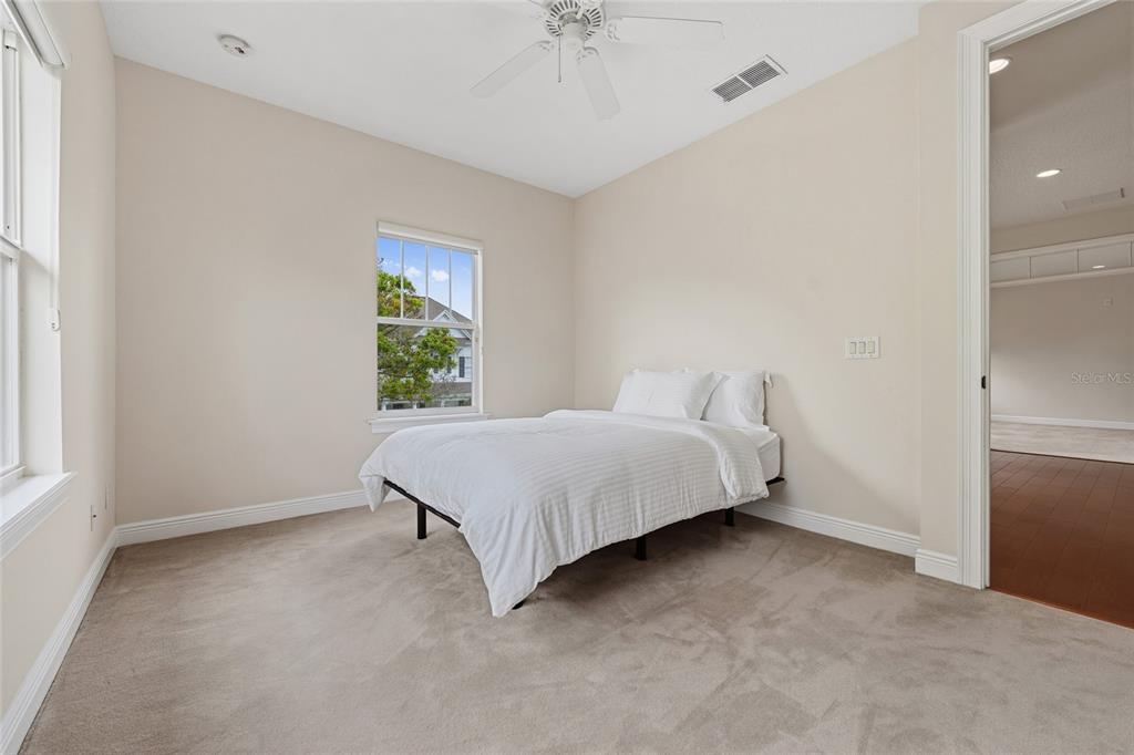 1027 Juel Street Orlando, FL 32814 - Photo 50 of 78 a spacious bedroom with a bed and a window