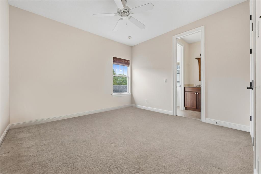 1027 Juel Street Orlando, FL 32814 - Photo 51 of 78 an empty room with a chandelier fan and windows