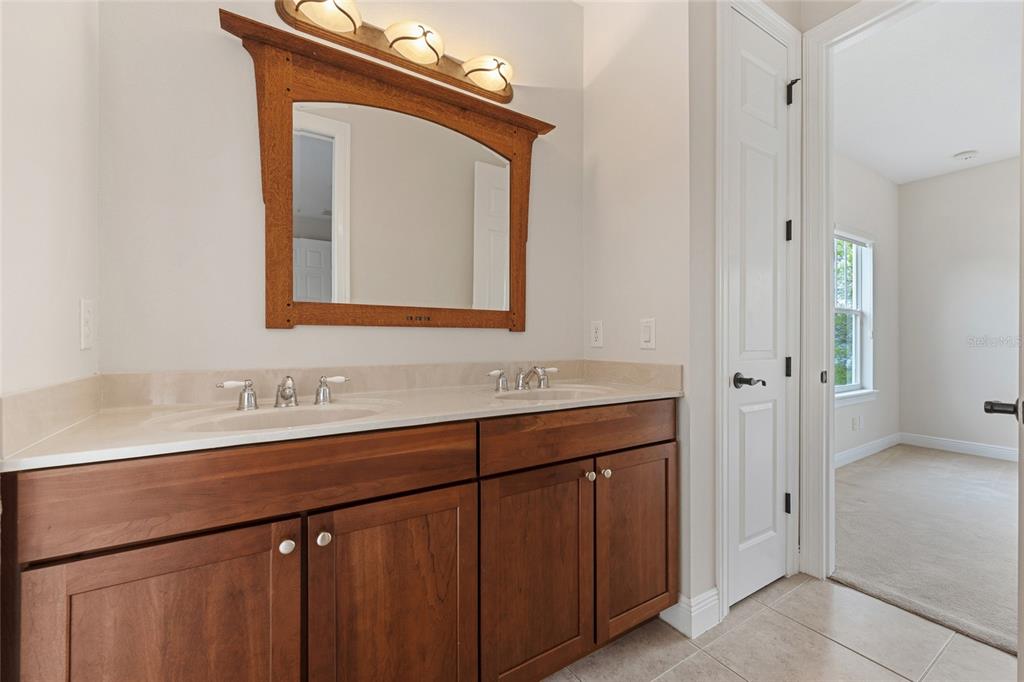 1027 Juel Street Orlando, FL 32814 - Photo 52 of 78 a bathroom with a sink vanity and a mirror
