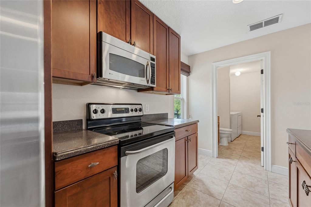 1027 Juel Street Orlando, FL 32814 - Photo 64 of 78 a kitchen with a stove and a microwave