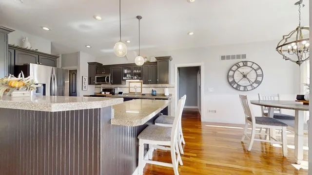 a view of a dining room with furniture a chandelier and wooden floor