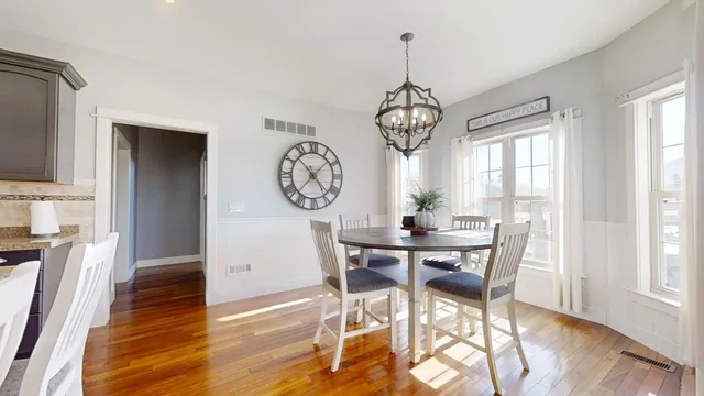 a large kitchen with stainless steel appliances granite countertop plenty wooden cabinets counter space a sink and a large window