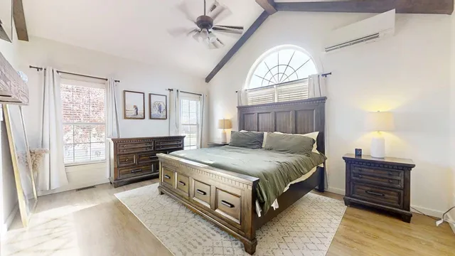 a bedroom with a bed and a window