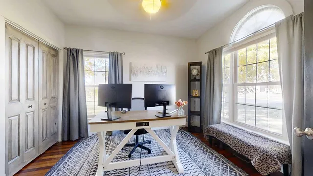 a kitchen with stainless steel appliances kitchen island granite countertop a table chairs in it and wooden floors