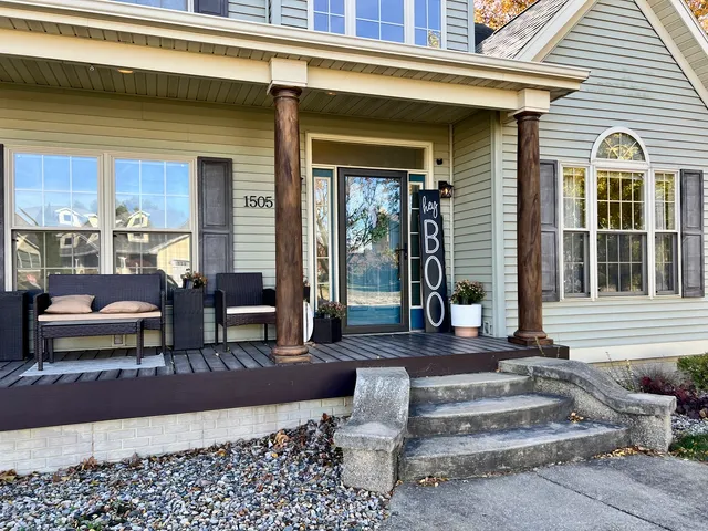 a front view of a house with outdoor seating