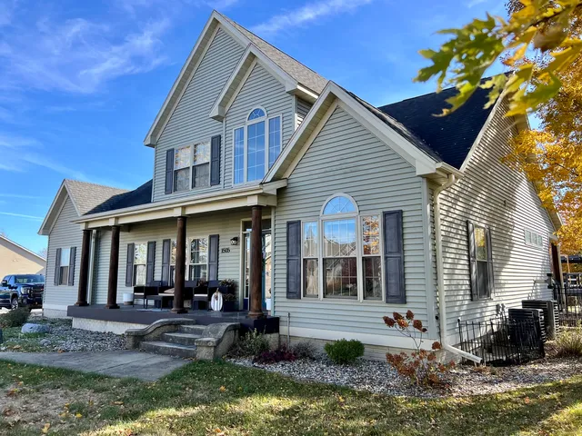 a front view of a house with garden and porch
