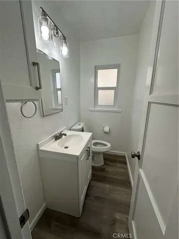 a bathroom with a sink a toilet and mirror