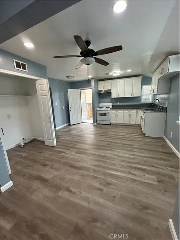 a view of a kitchen with a sink and cabinets