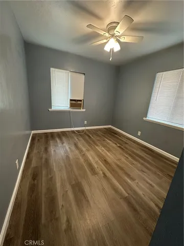 a view of room with a ceiling fan and window