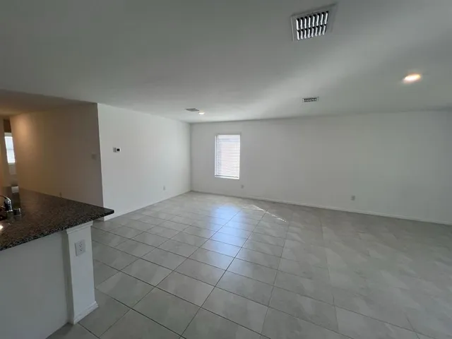 an empty room with a empty space and windows