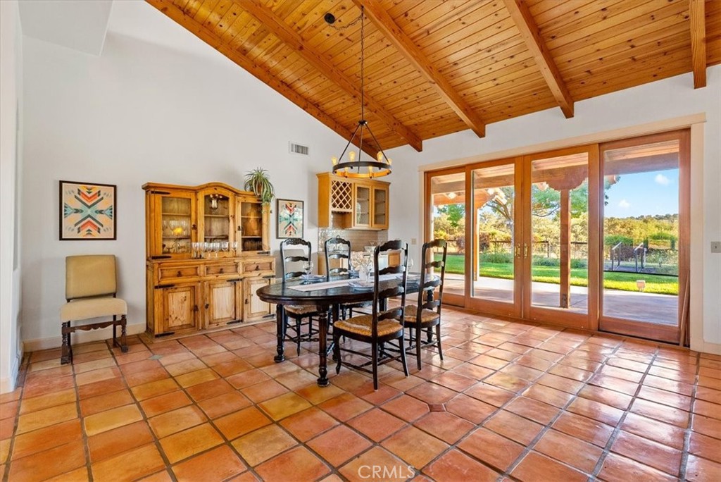 5745 Iron Gate Road Paso Robles, CA 93446 - Photo 14 of 58 Dining Area and Wet Bar. Huge windows and doors open to backyard and take in the lush landscaping.