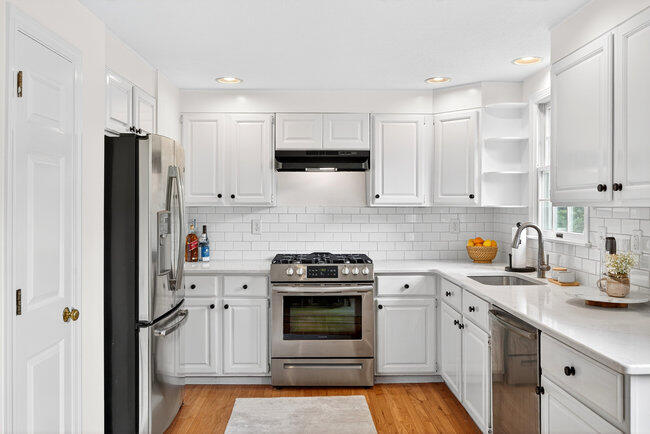 20 Mutiny Way Mashpee, MA 02649 - Photo 14 of 36 a kitchen with stainless steel appliances a stove a sink and a refrigerator