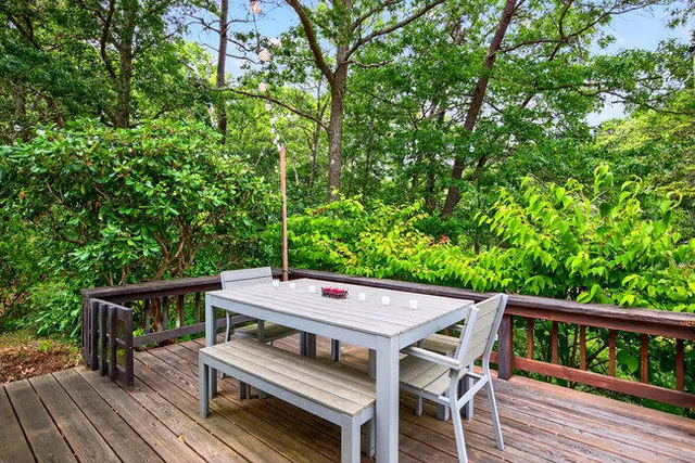 a view of a dinning table and chairs in the roof deck