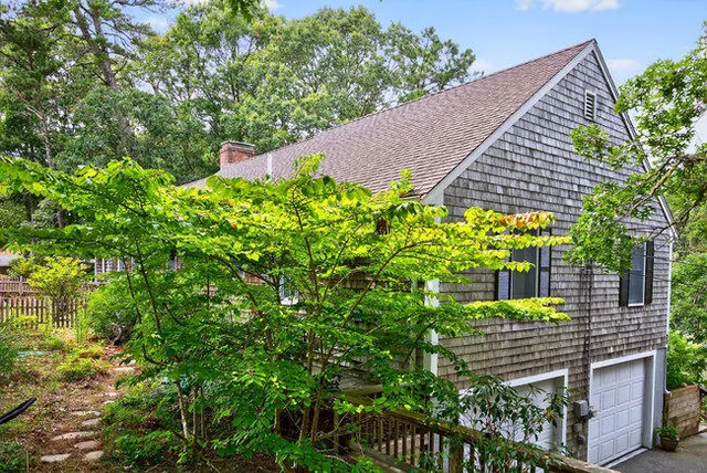 a view of a house with a yard and plants
